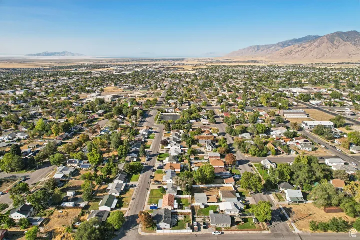 Aerial view of property's location with mountains and nearby suburban area