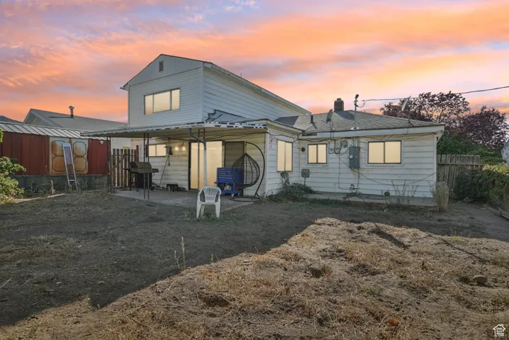 Rear view of property featuring a patio and a chimney