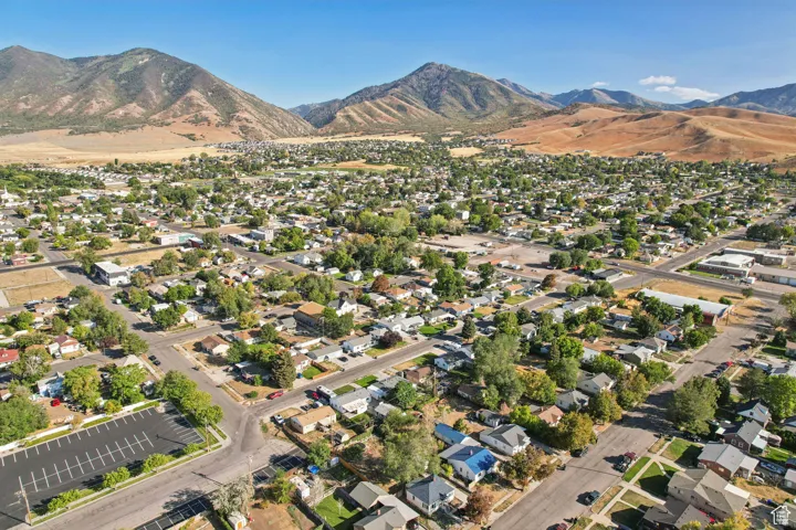 Aerial overview of property's location featuring nearby suburban area and a mountainous background