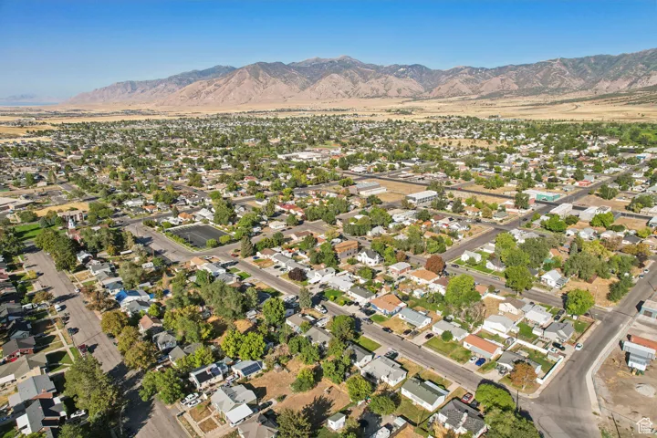 Aerial view of property's location with nearby suburban area and mountains