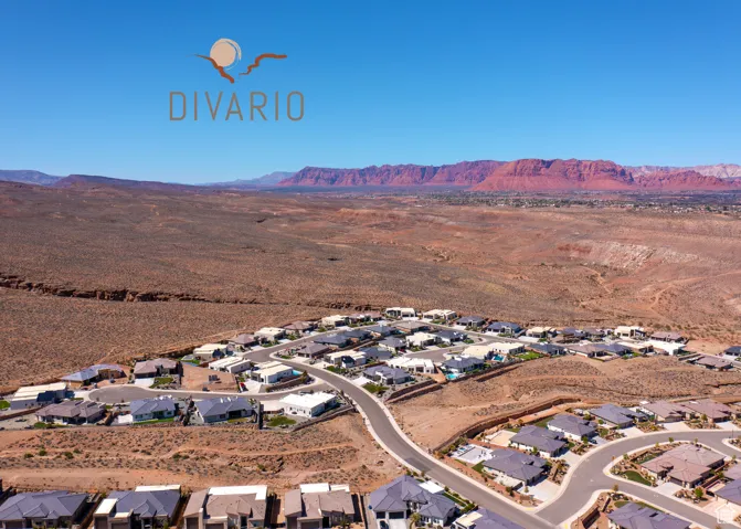 Aerial view of property's location with nearby suburban area and a mountainous background