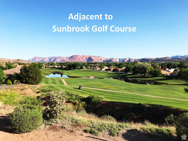 Surrounding community featuring a water and mountain view, view of golf course, and a lawn