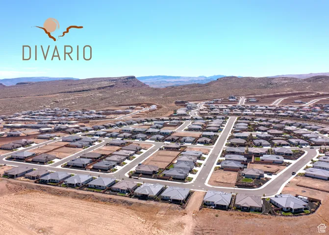Aerial view of property and surrounding area with a mountainous background and nearby suburban area