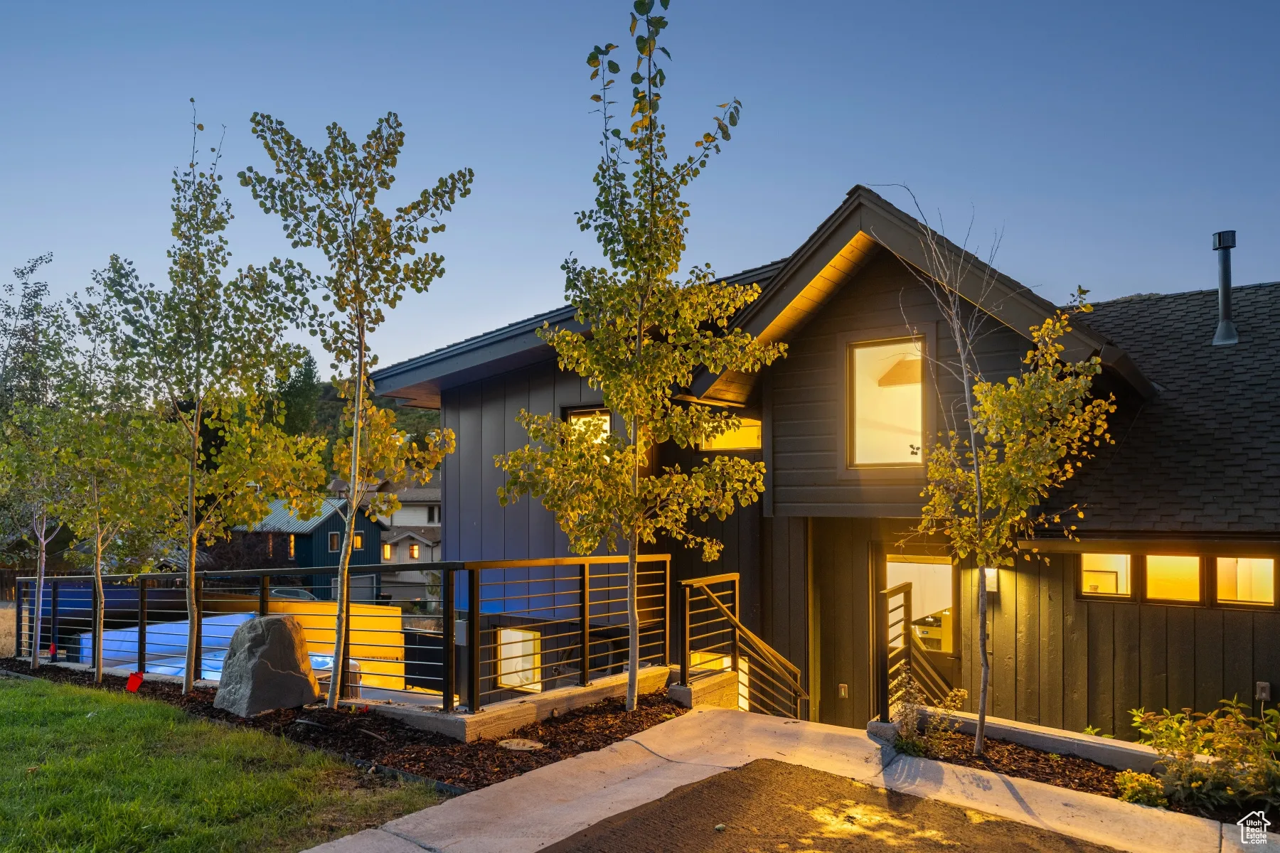 View of front of house featuring a shingled roof and board and batten siding