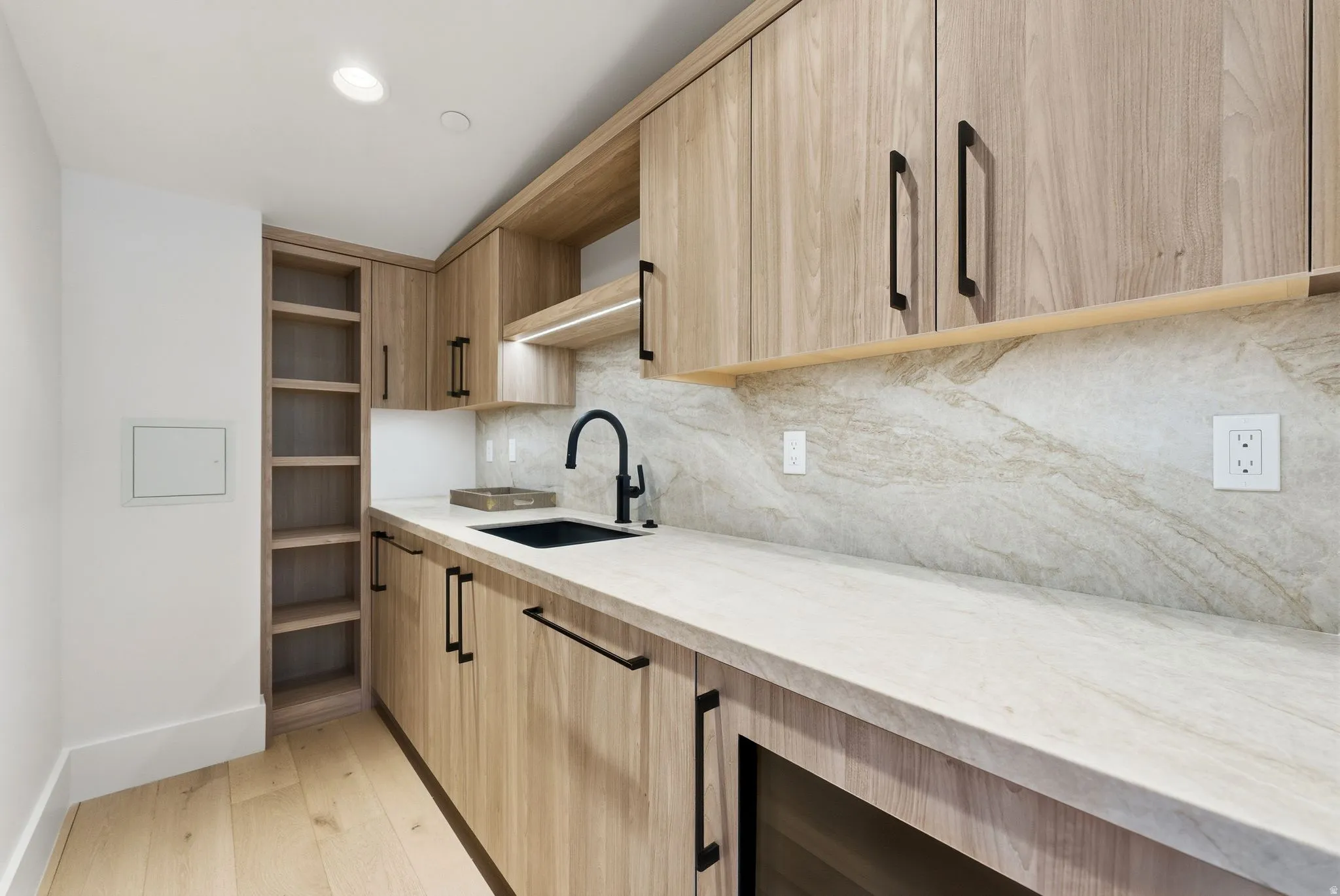 Kitchen featuring open shelves, light brown cabinetry, backsplash, light stone counters, and recessed lighting