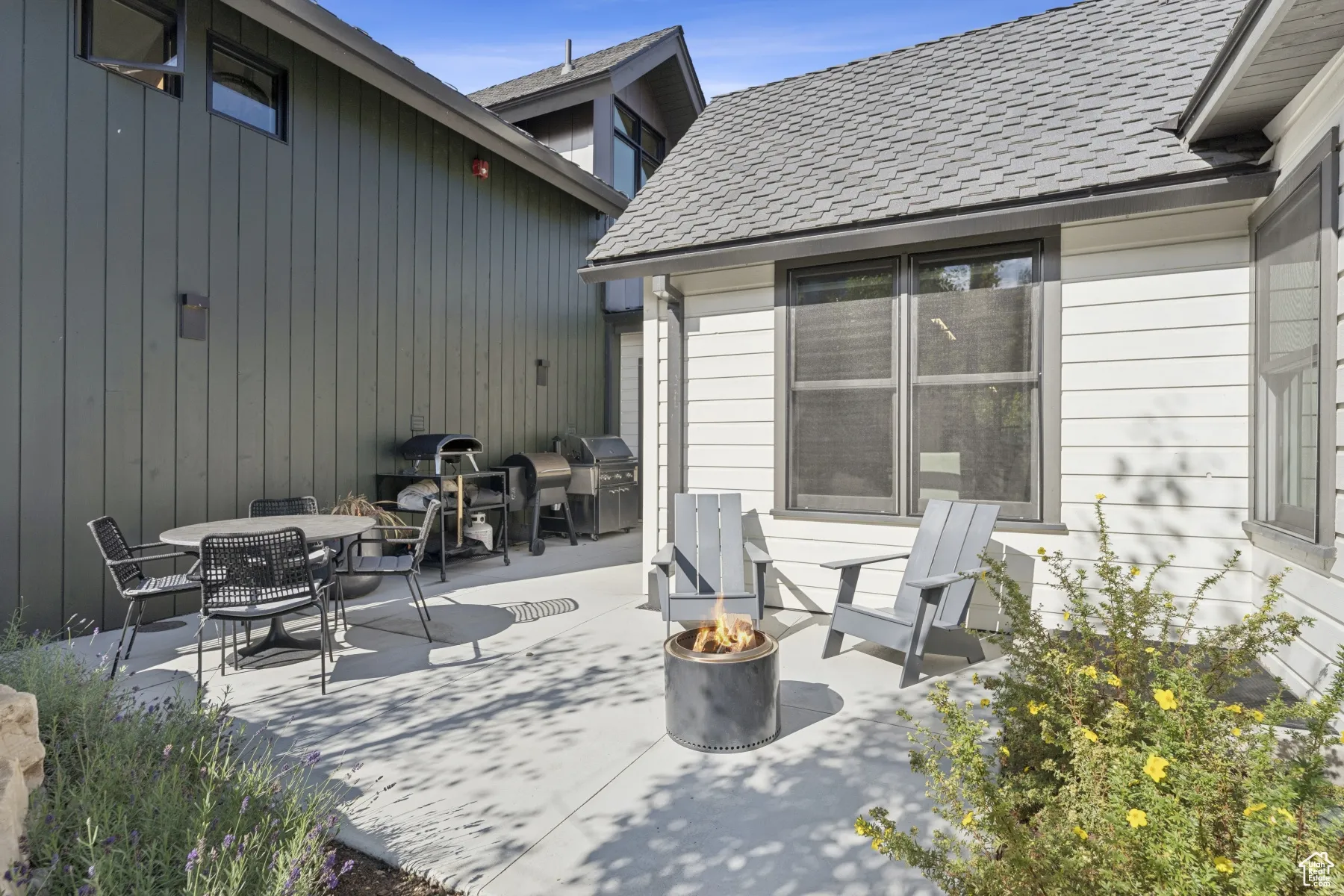 View of patio featuring a fire pit, outdoor dining area, and grilling area