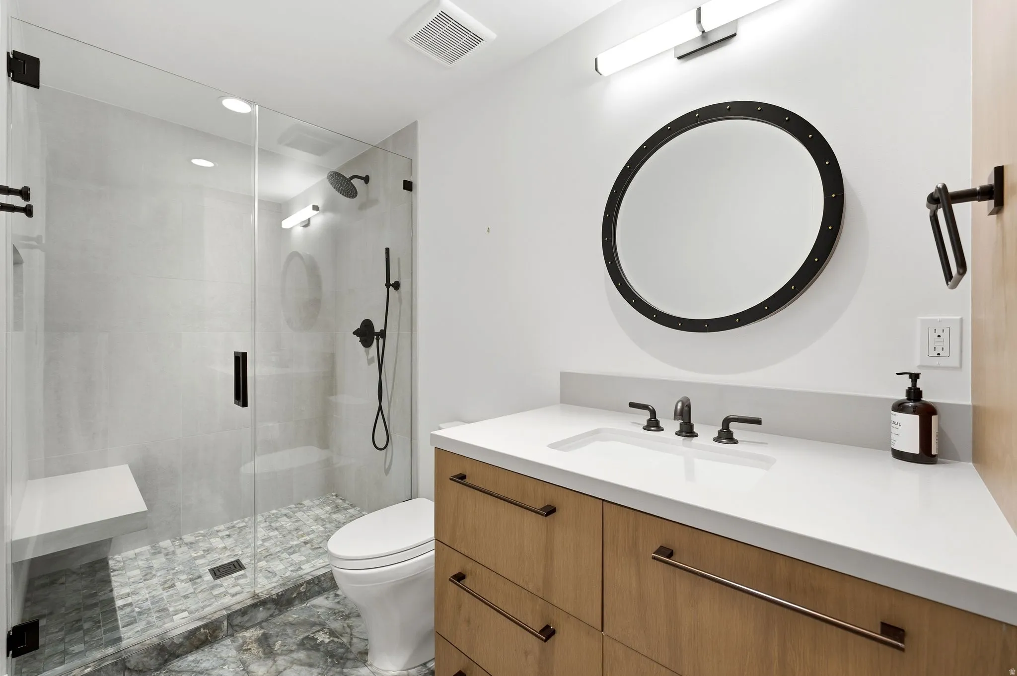 Full bathroom with a stall shower, vanity, recessed lighting, and light marble finish flooring