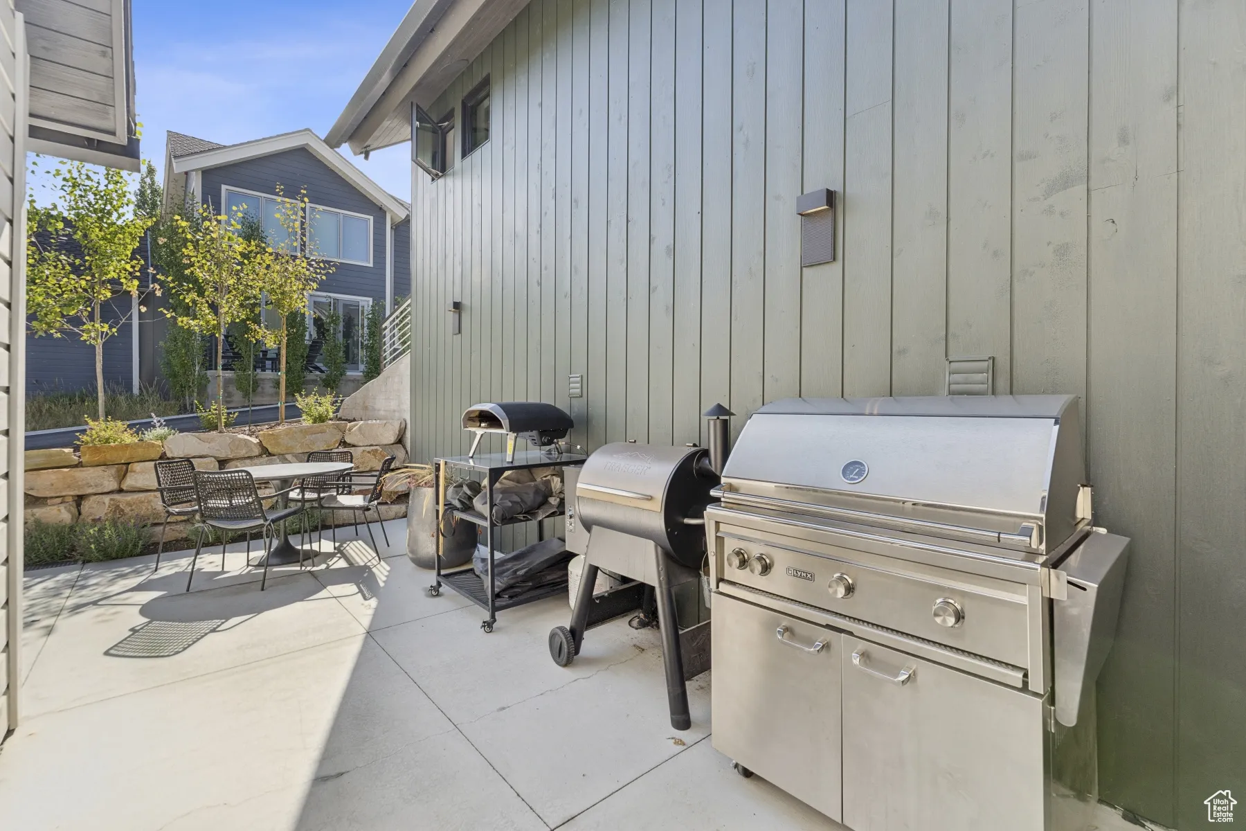 View of patio featuring area for grilling and outdoor dining space