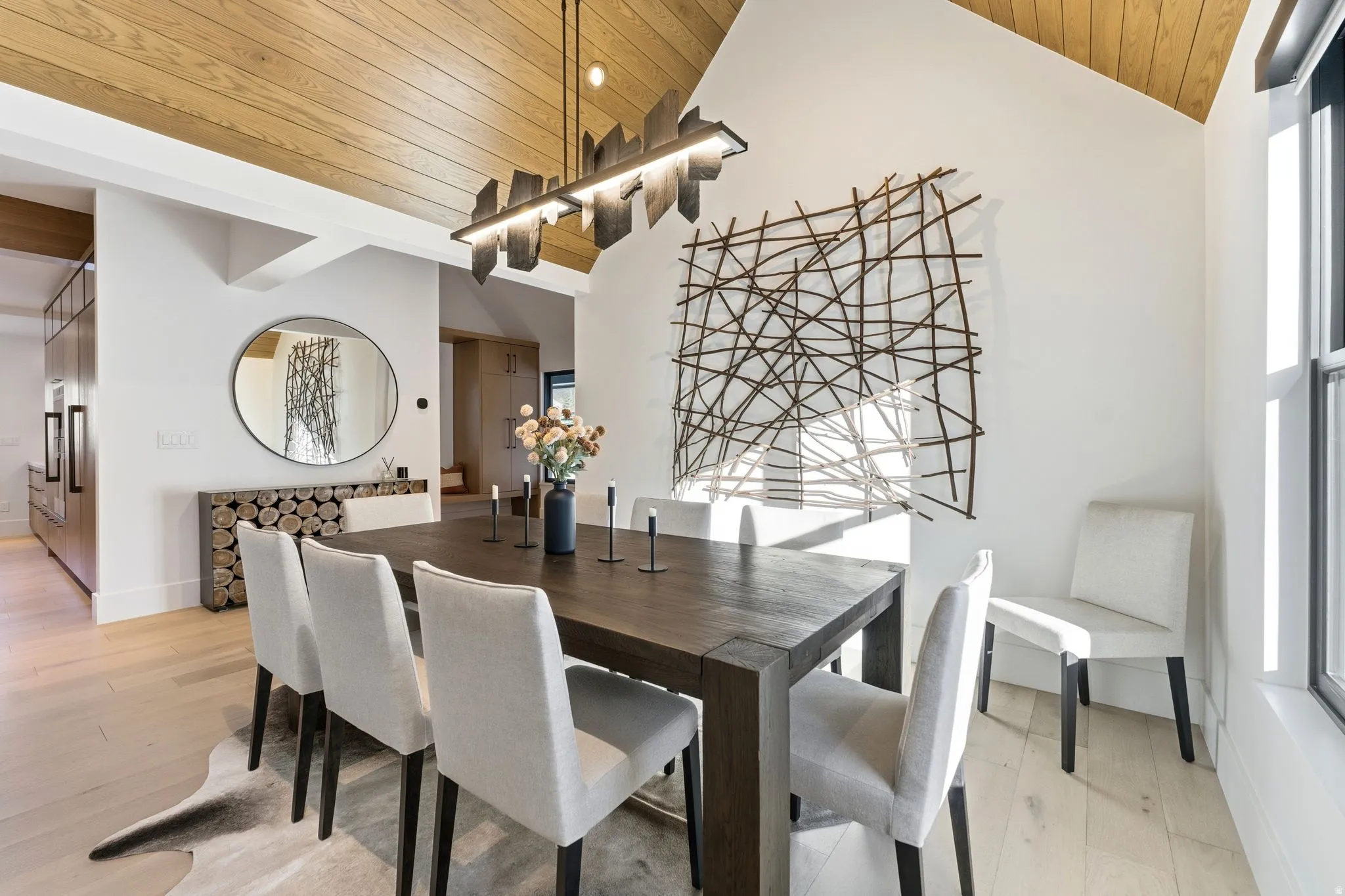 Dining area with wooden ceiling, light wood-style flooring, and vaulted ceiling