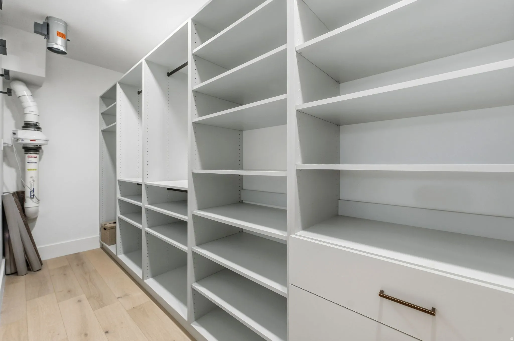 Spacious closet with light wood-style flooring