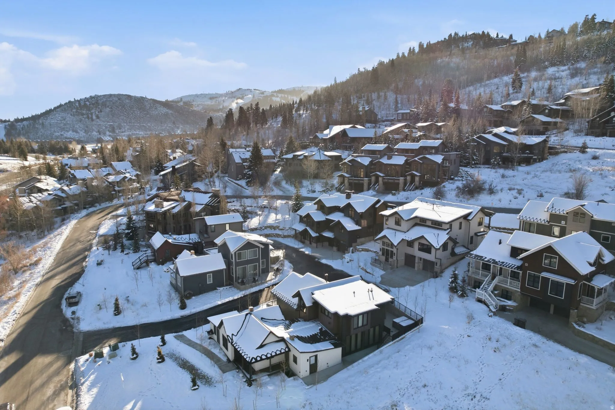 Snowy aerial view with a mountain view and a residential view