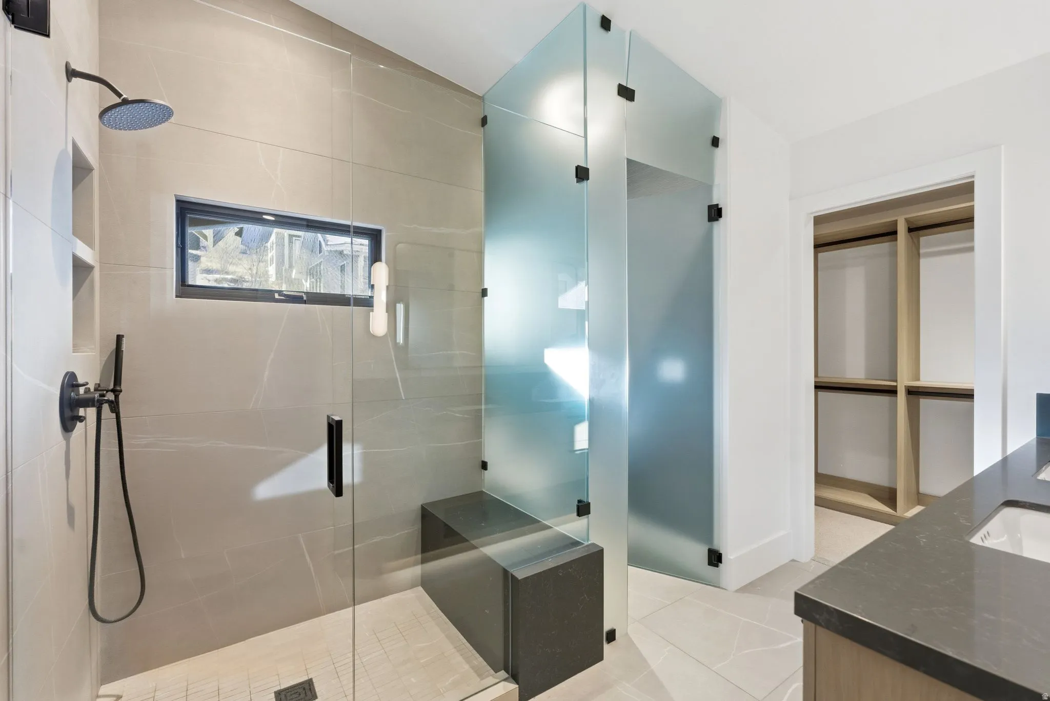 Bathroom featuring vanity, a shower stall, and light tile patterned floors