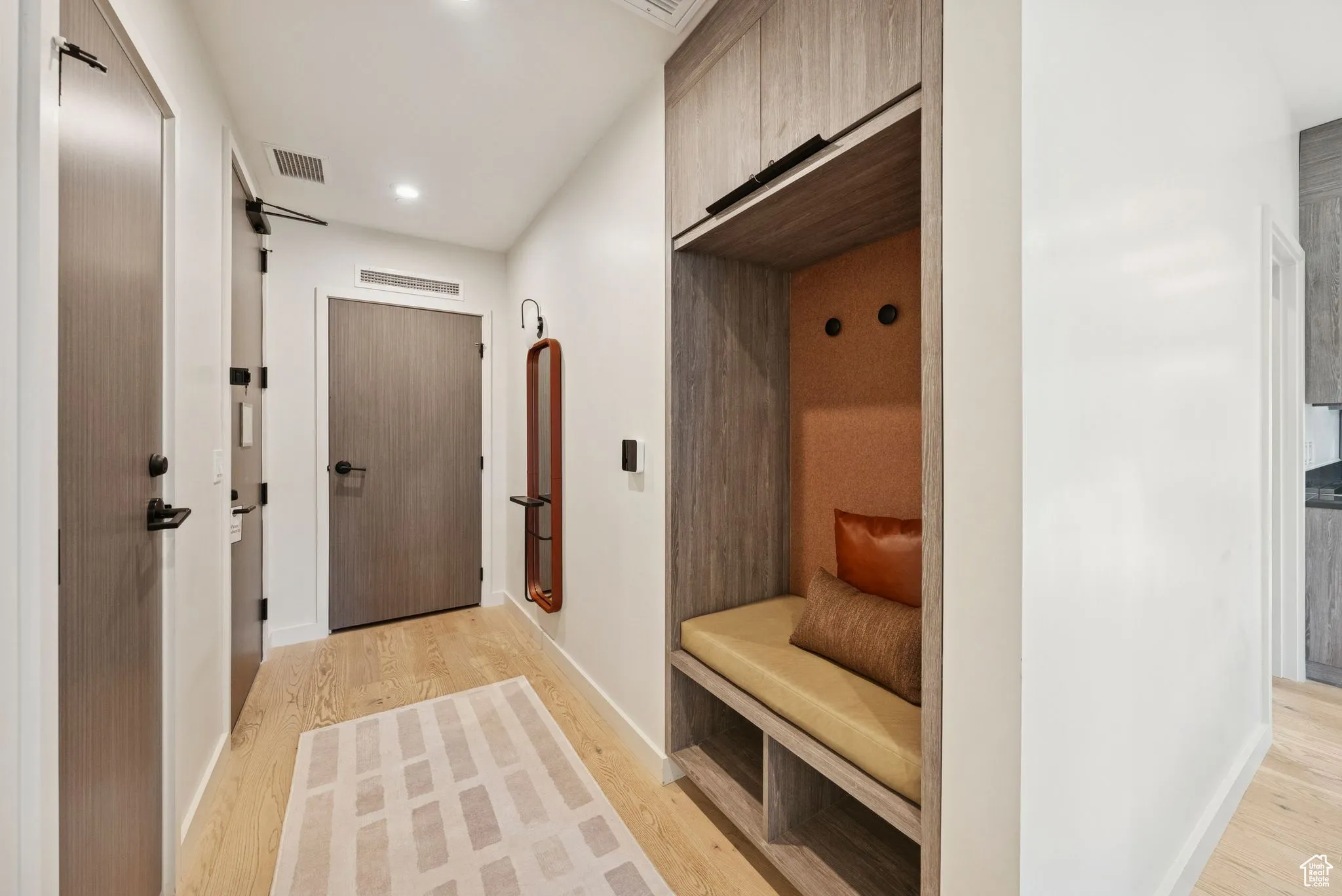 Mudroom featuring light wood-type flooring and recessed lighting