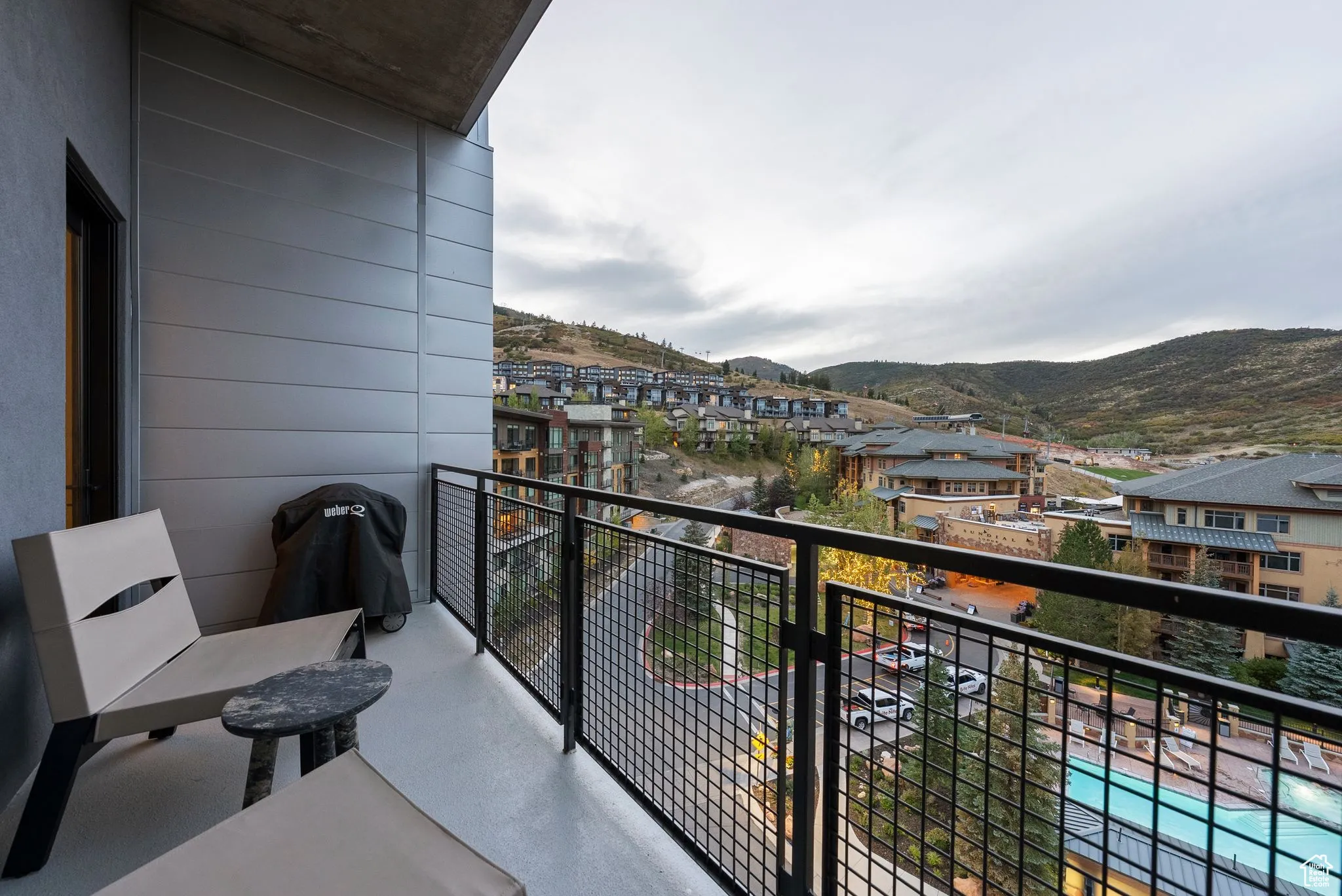 Balcony featuring a mountain view and view of pool