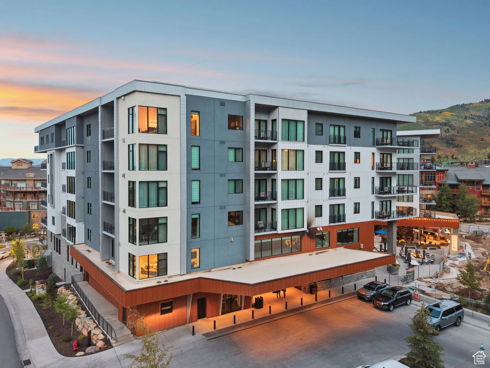 Property at dusk featuring a view of apartment building / complex