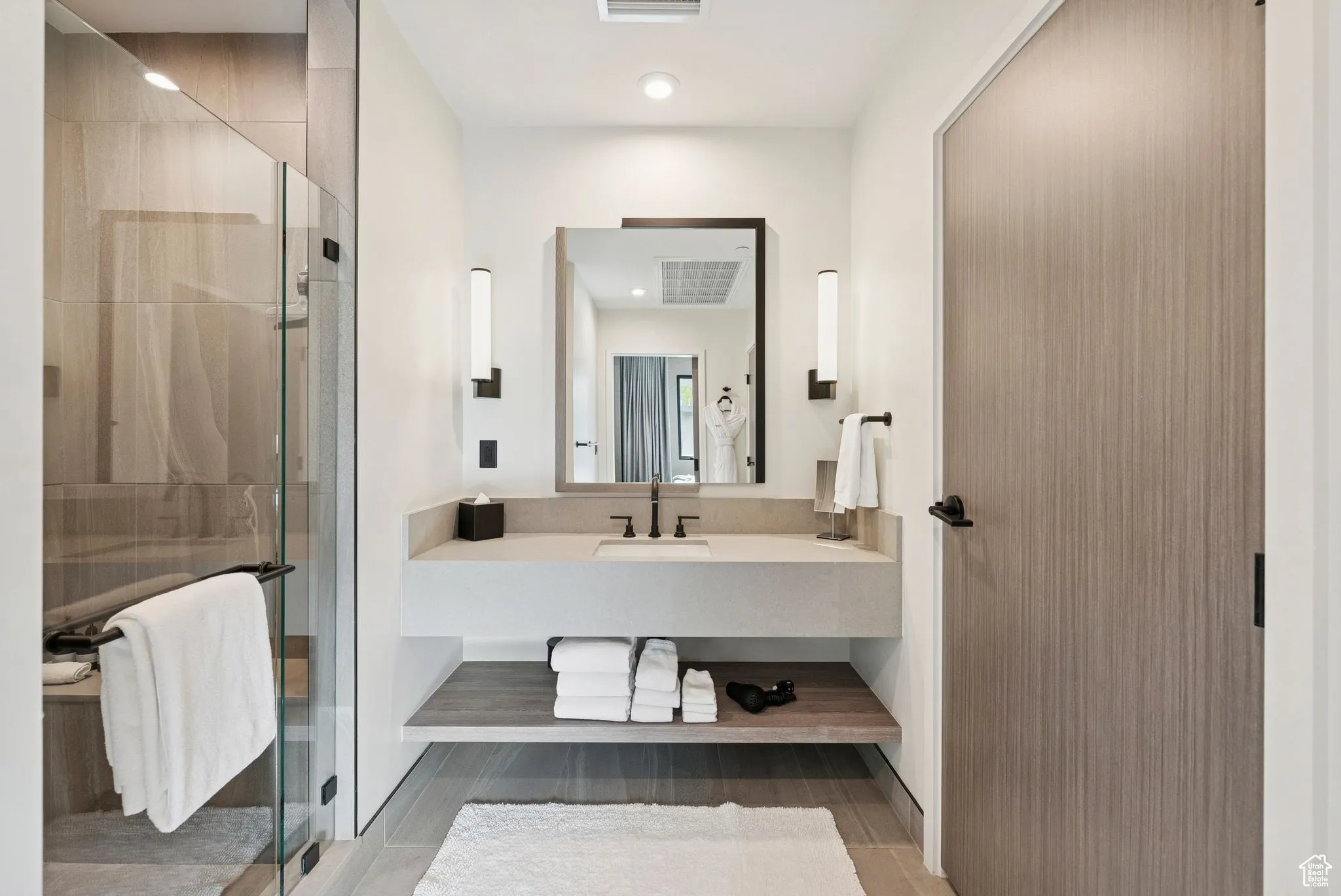 Bathroom featuring a stall shower, vanity, and recessed lighting