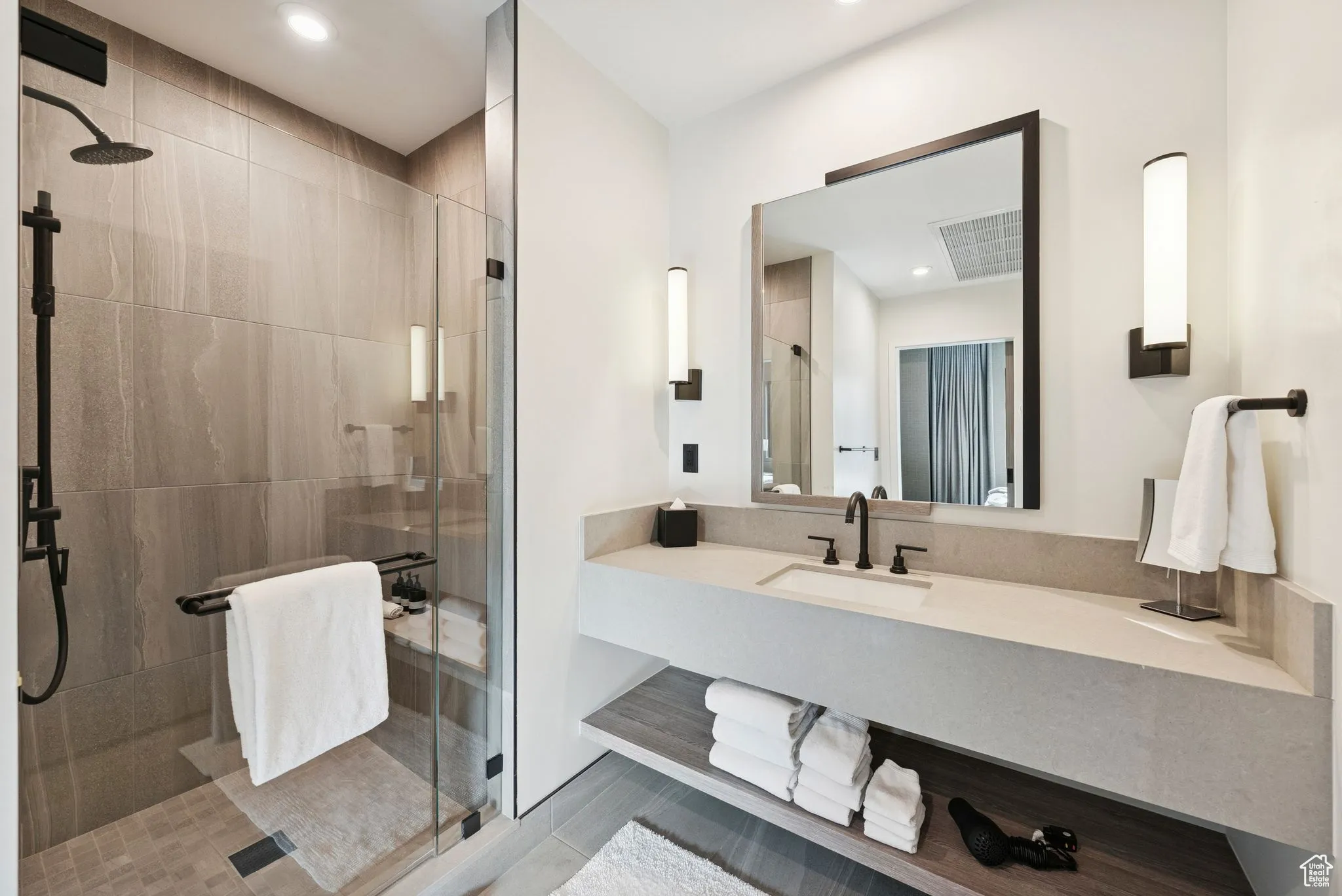 Bathroom with a shower stall, vanity, recessed lighting, and light tile patterned floors