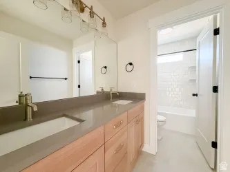Full bath with double vanity and bathing tub / shower combination