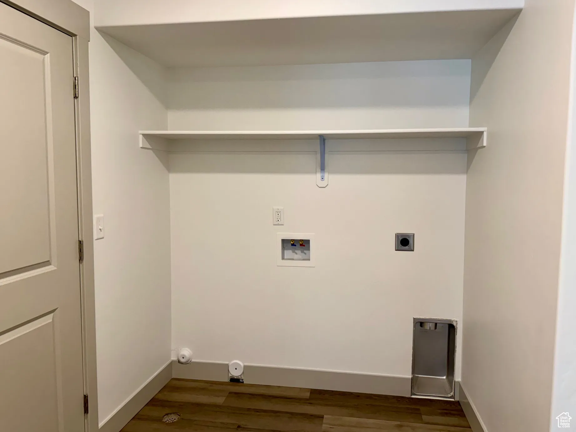 Laundry area featuring dark wood-type flooring, hookup for a washing machine, and hookup for an electric dryer