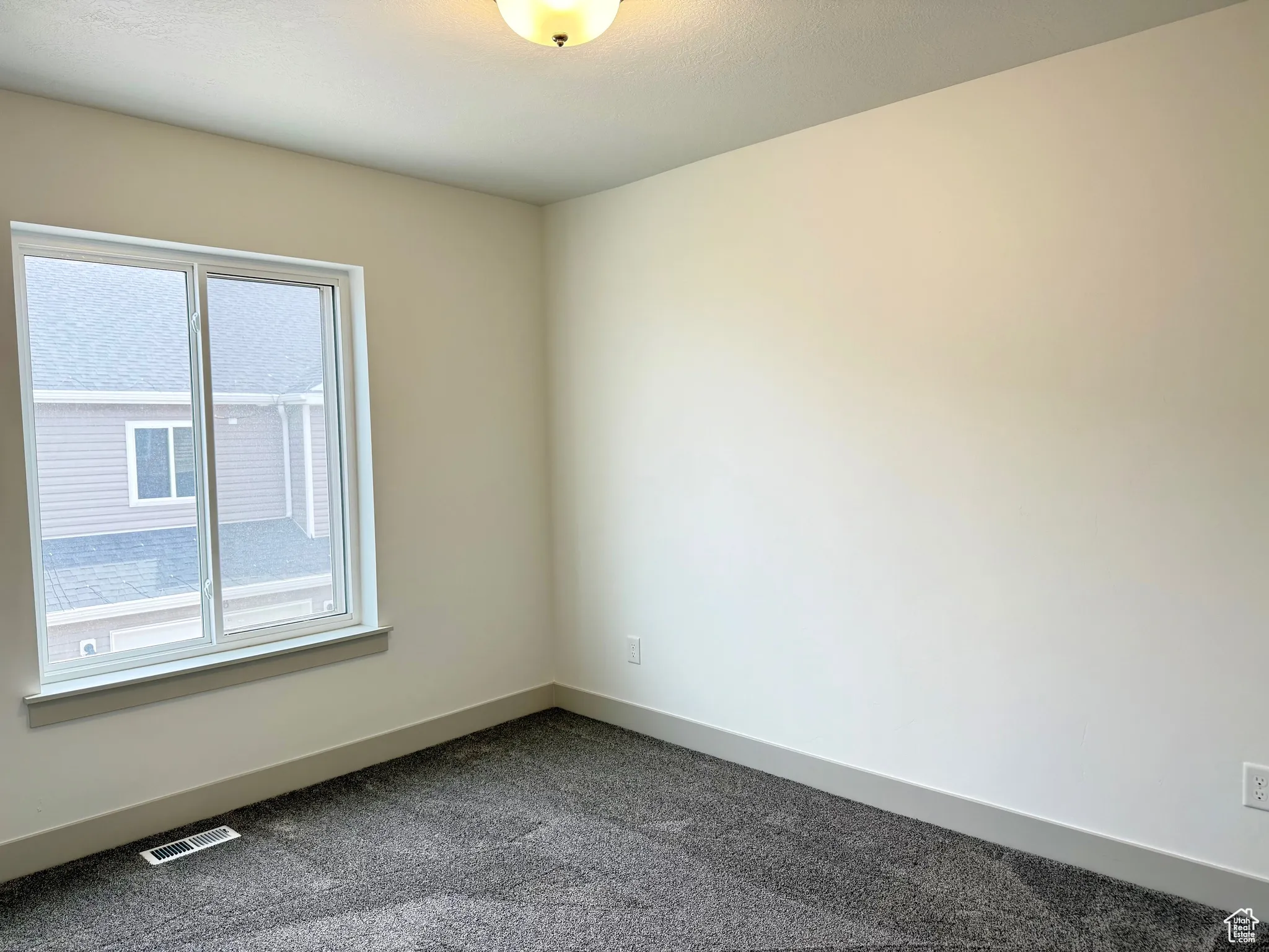 bedroom featuring baseboards and dark carpet