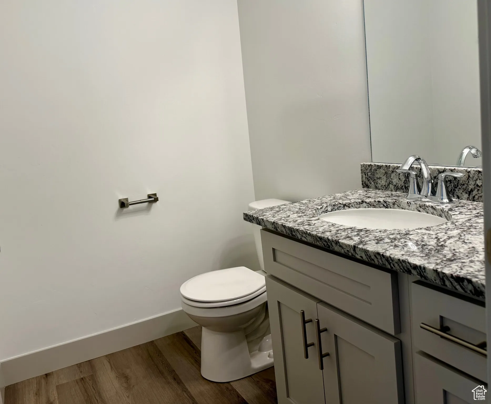 Bathroom with vanity and dark wood-type flooring and shower