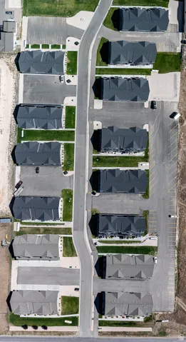 Aerial view of property and surrounding area with nearby suburban area