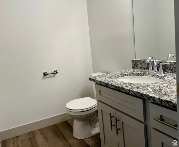 Bathroom with vanity and dark wood-type flooring and shower