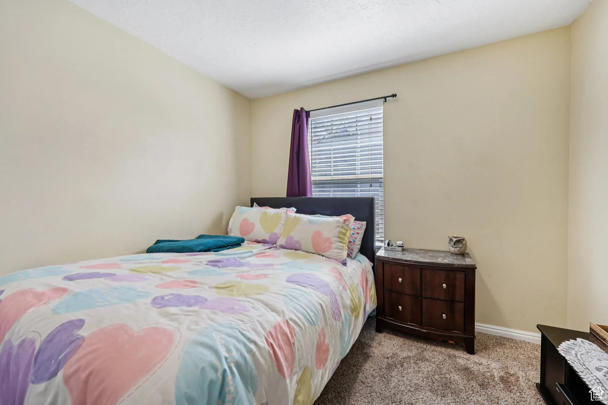 Bedroom featuring carpet floors and a textured ceiling