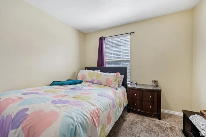 Bedroom featuring carpet floors and a textured ceiling