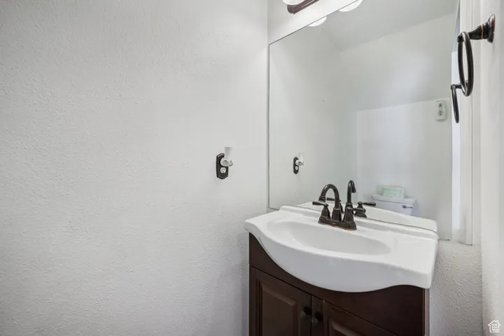 Bathroom featuring vanity and a textured wall