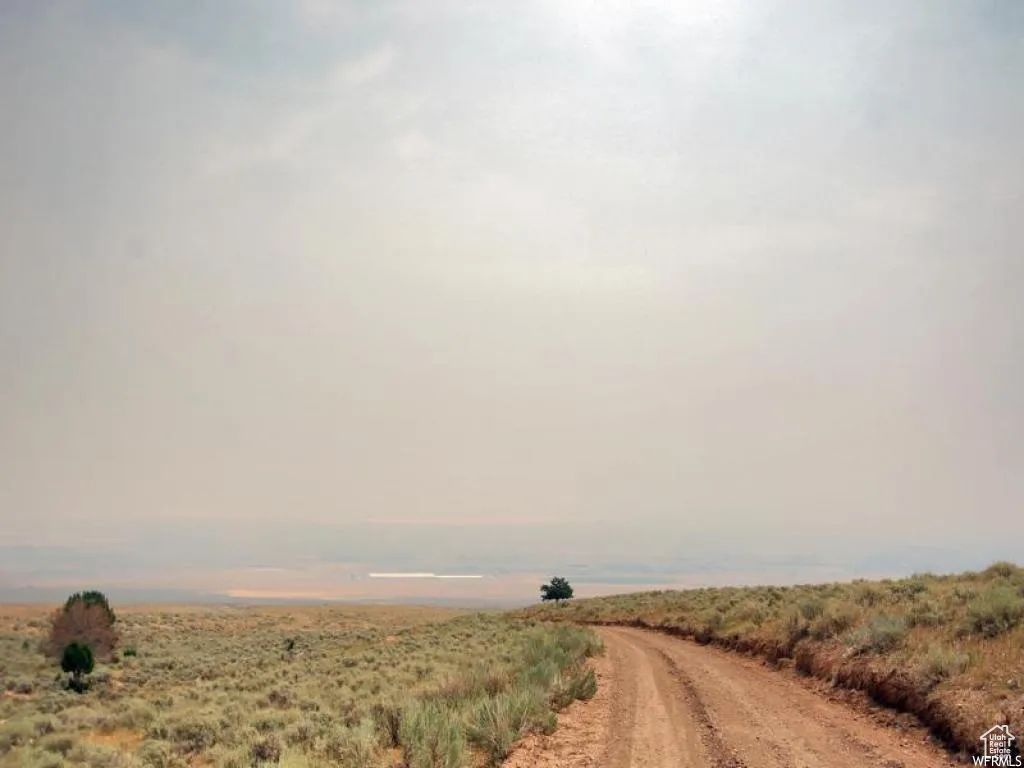 View of dirt / gravel road featuring a view of countryside