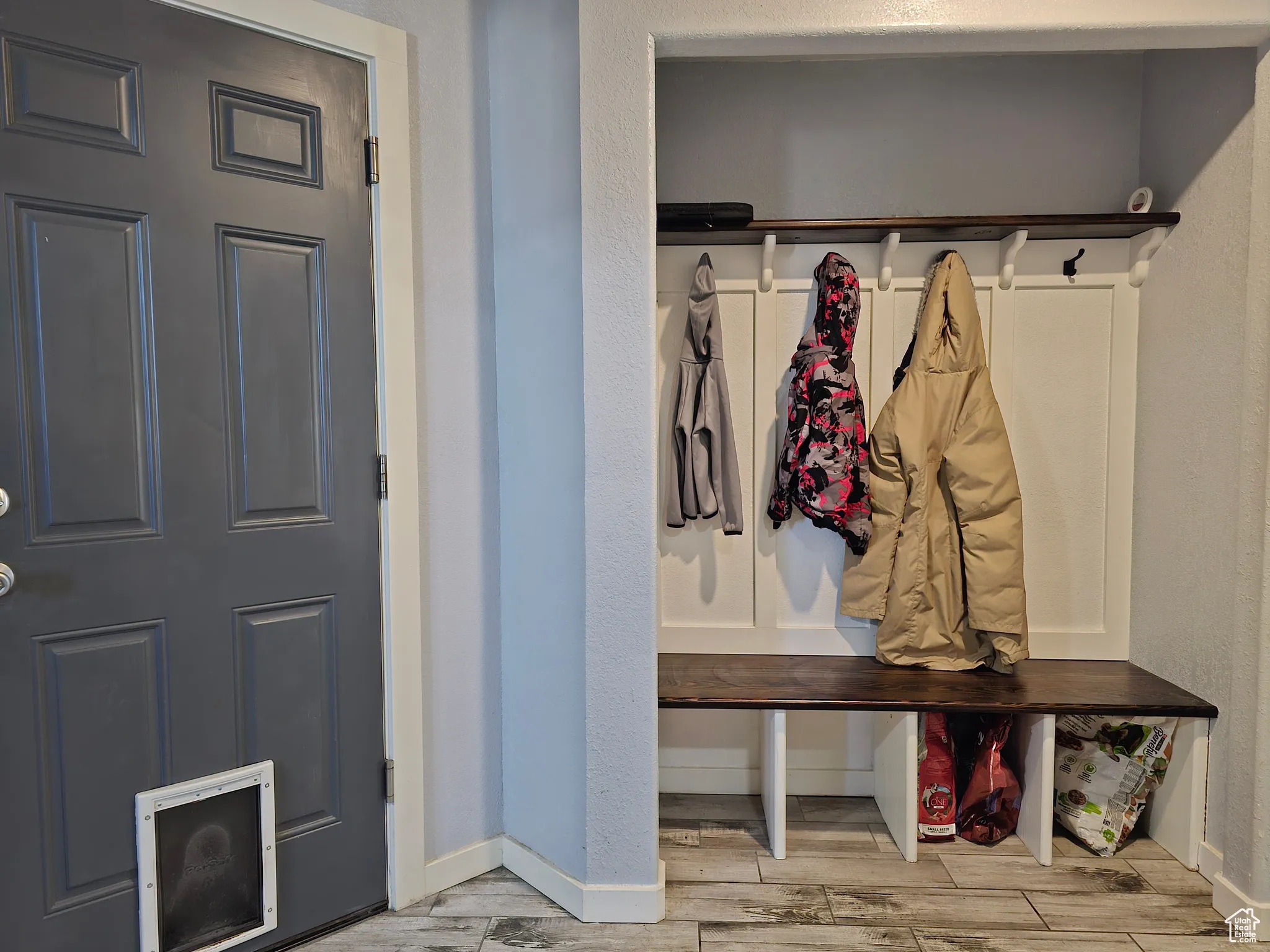 Mudroom featuring wood tiled floors and baseboards
