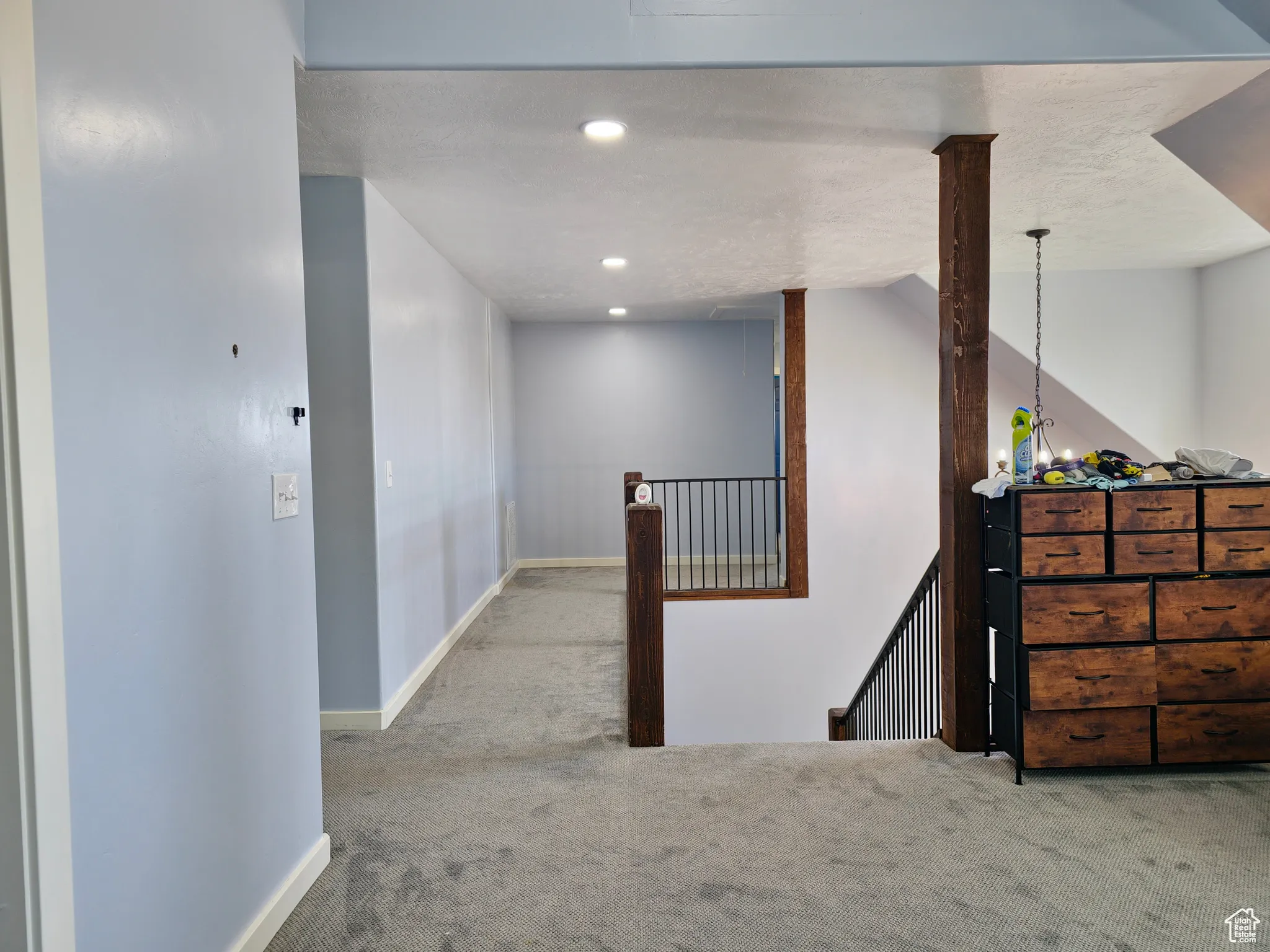 Hallway featuring carpet flooring, recessed lighting, an upstairs landing, a chandelier, and a textured ceiling