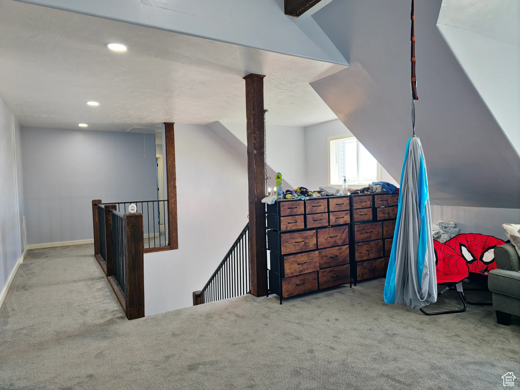 Additional living space featuring light colored carpet, recessed lighting, and a textured ceiling