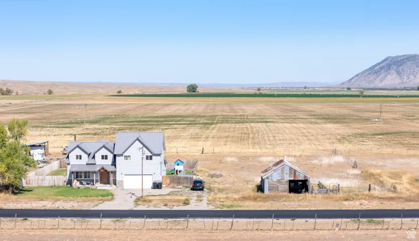 View of rural area with large plots for crops and a mountainous background