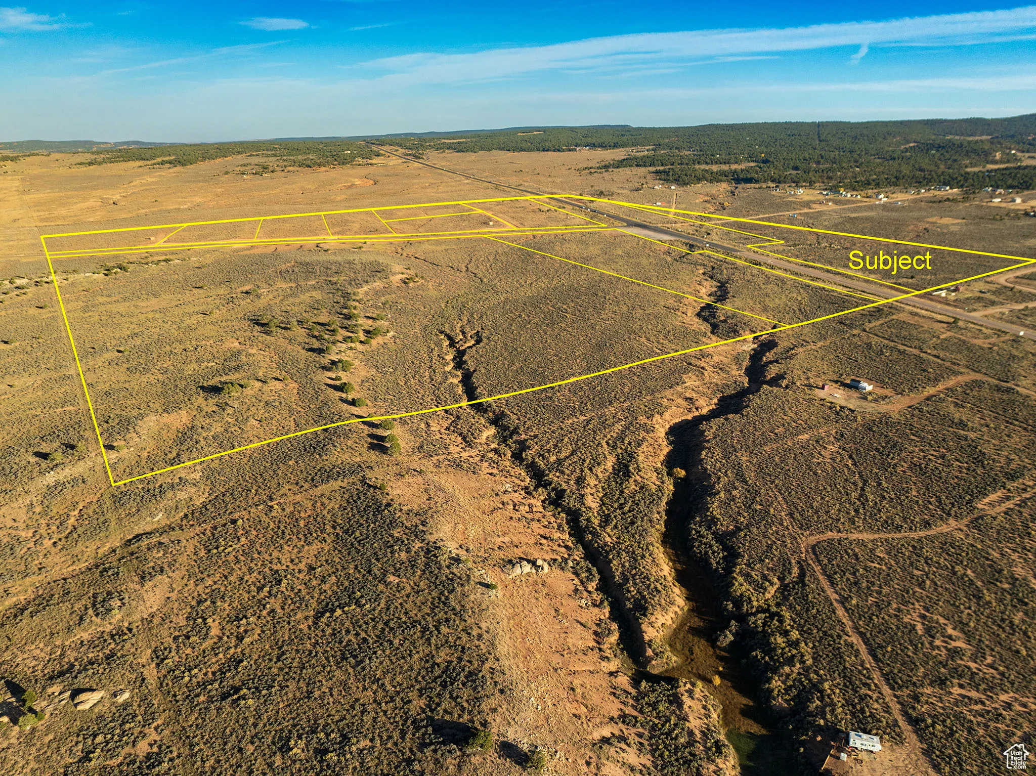 Aerial view of property's location with a mountainous background and rural landscape