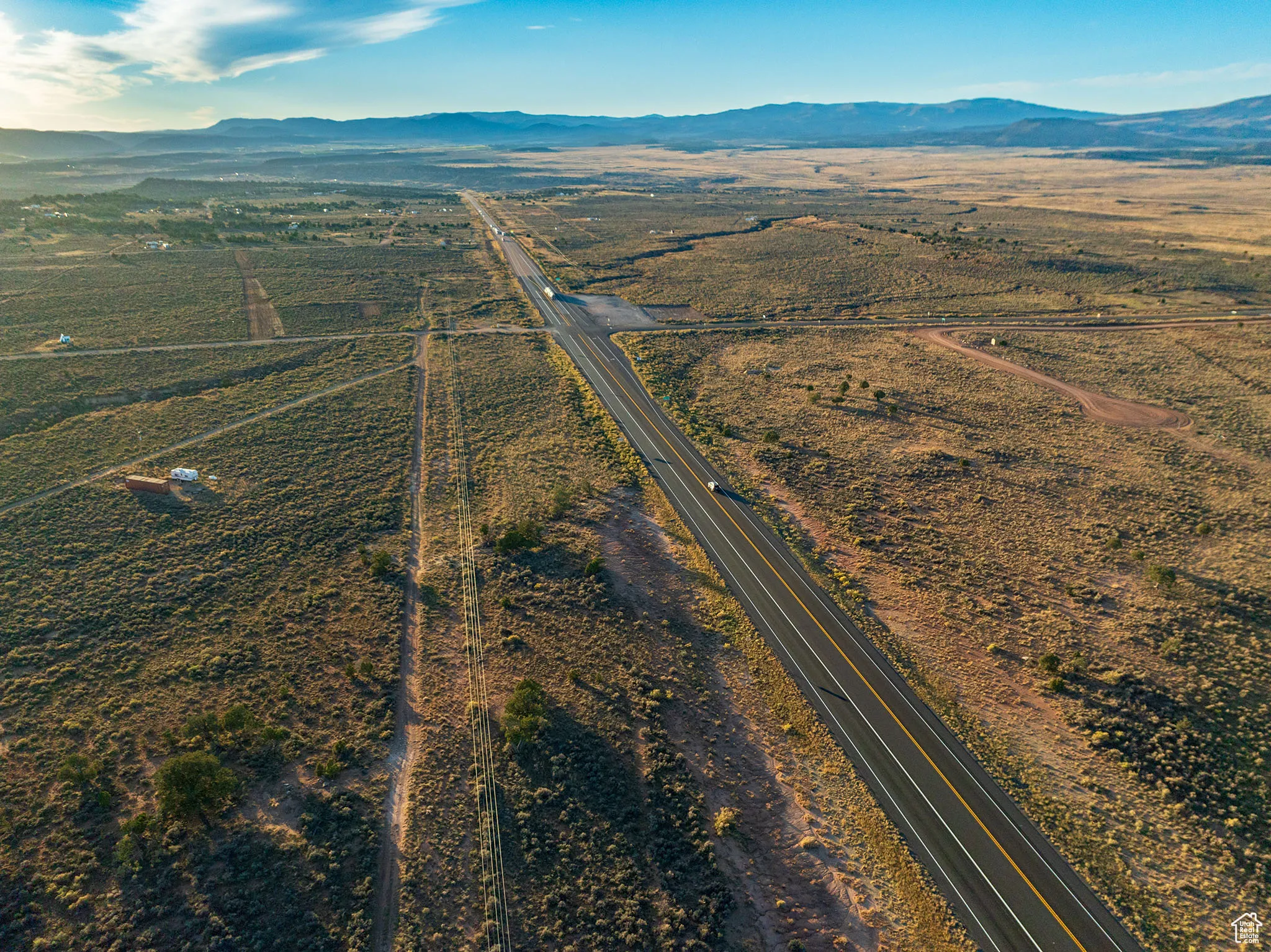 Aerial view of property's location with a mountainous background and rural landscape