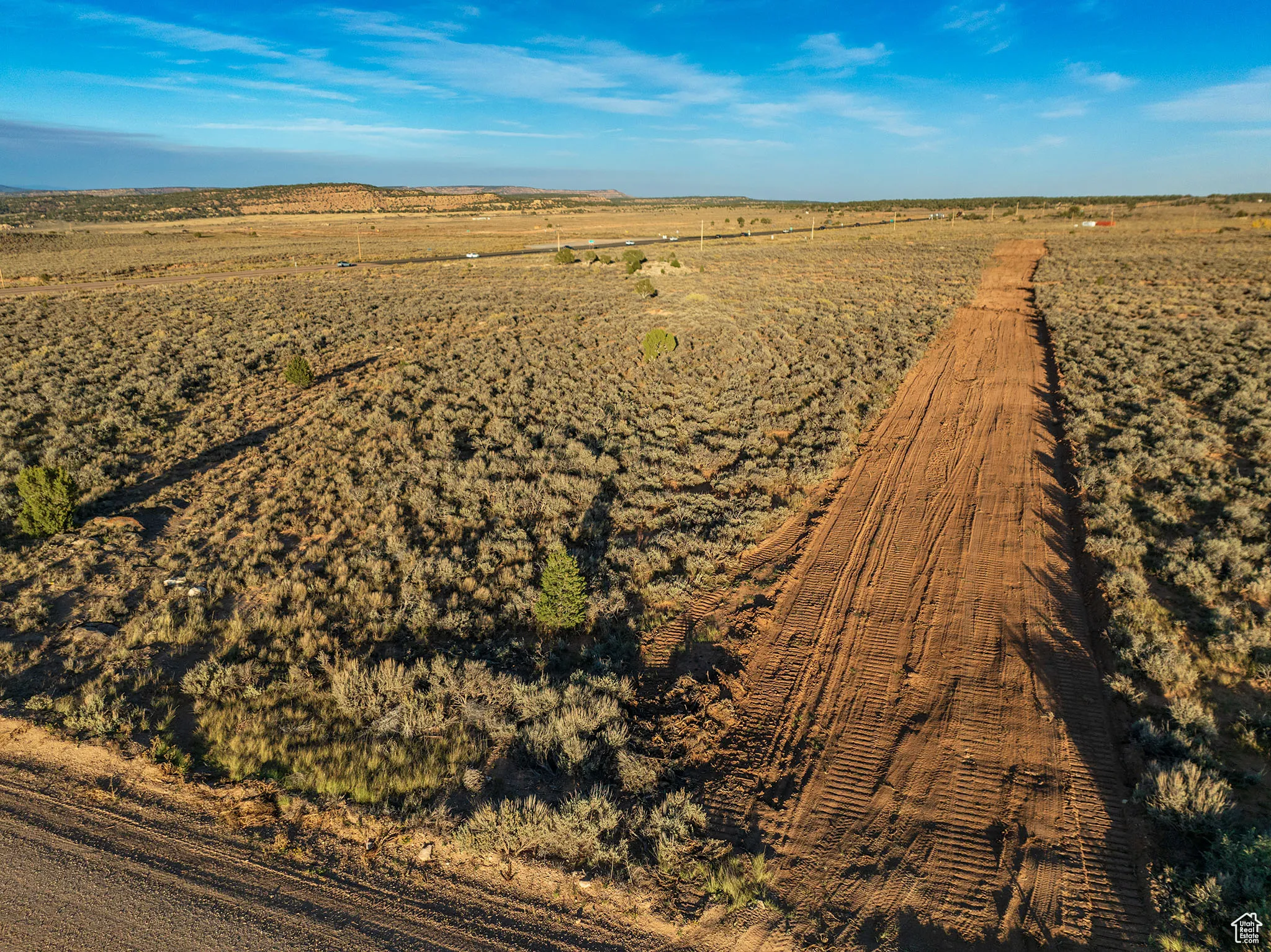 Aerial view of property's location with a mountainous background and rural landscape