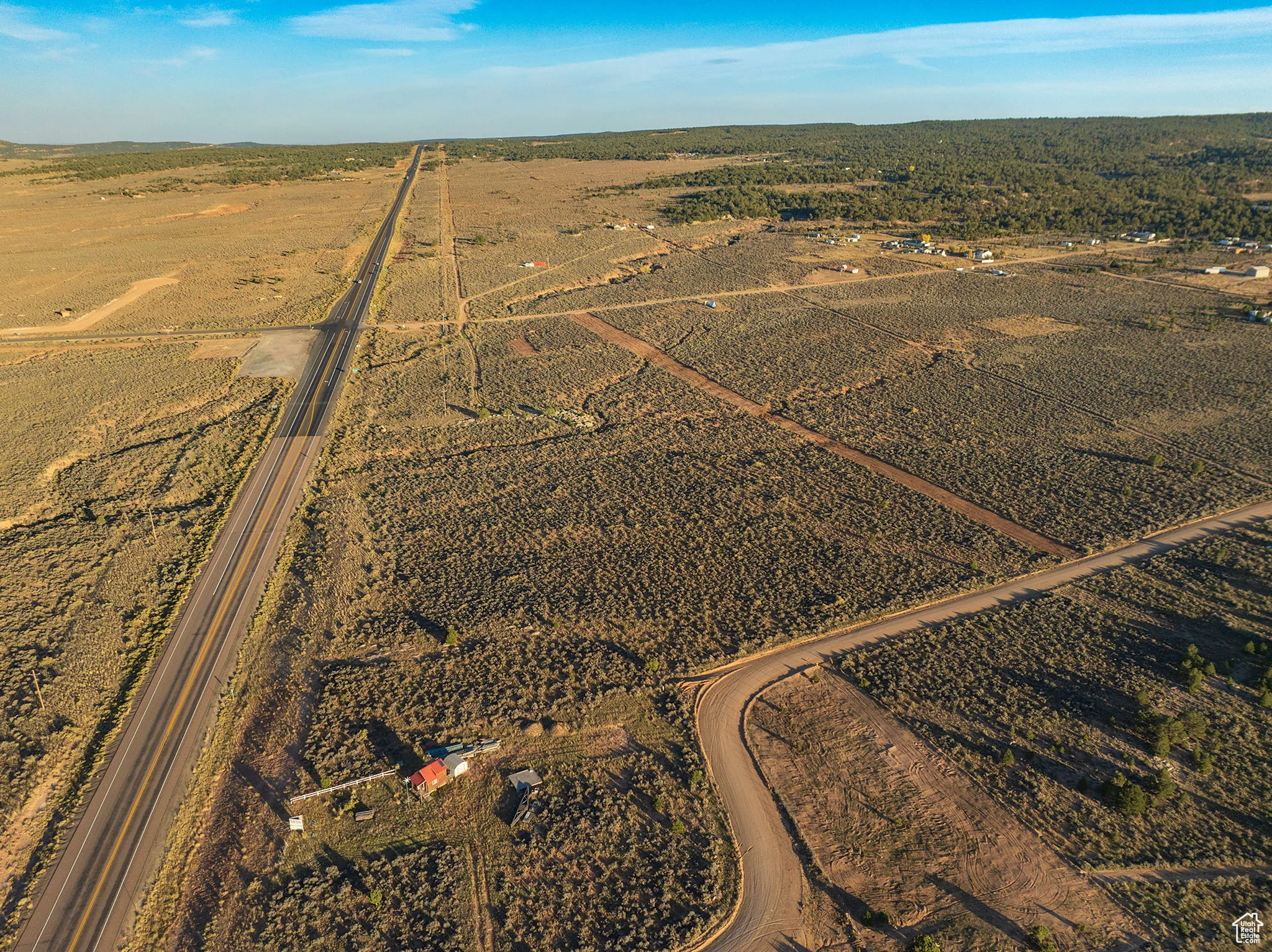 Aerial view of property's location with a mountainous background and rural landscape