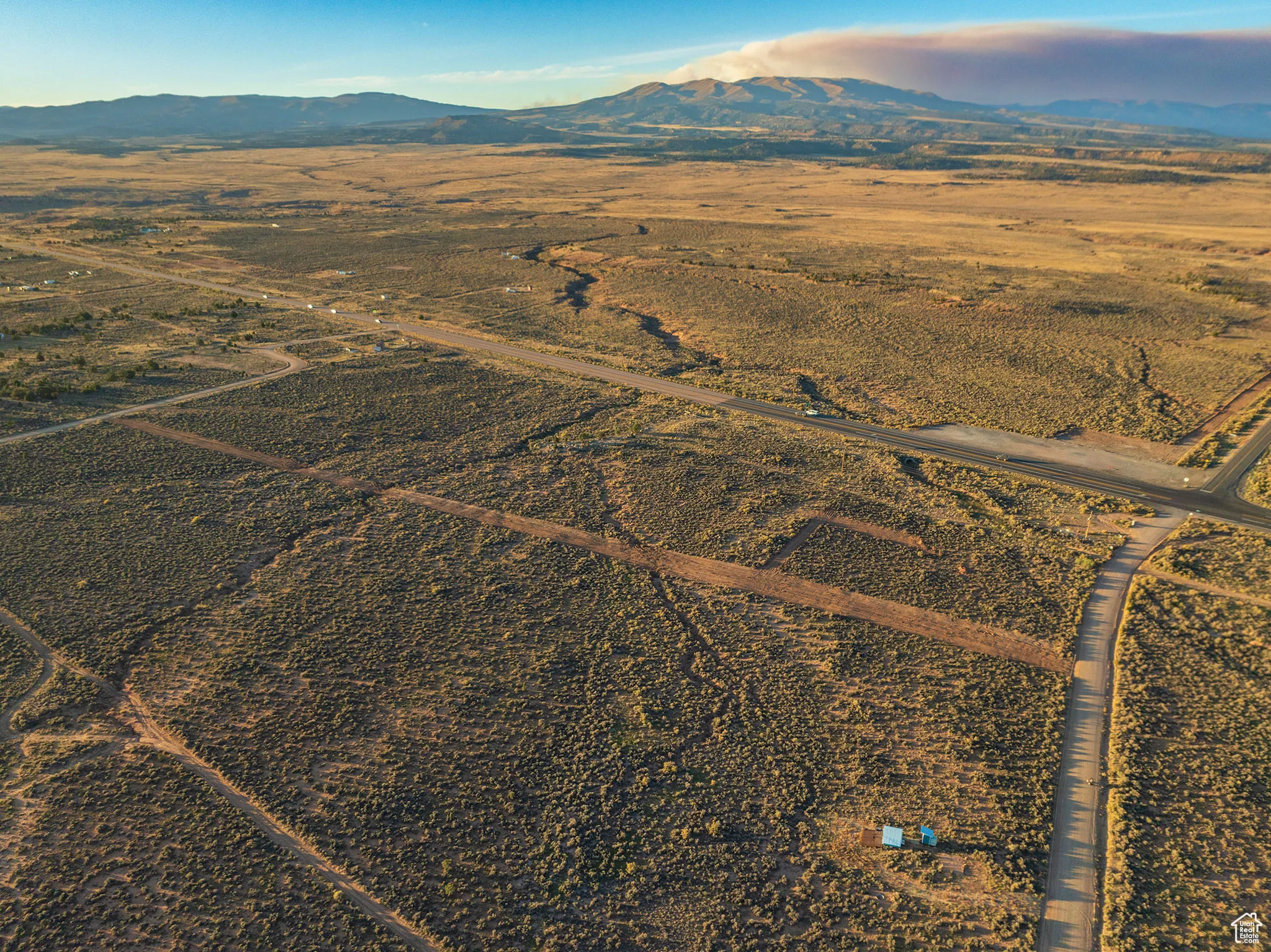 Aerial view of property's location with a mountainous background and rural landscape