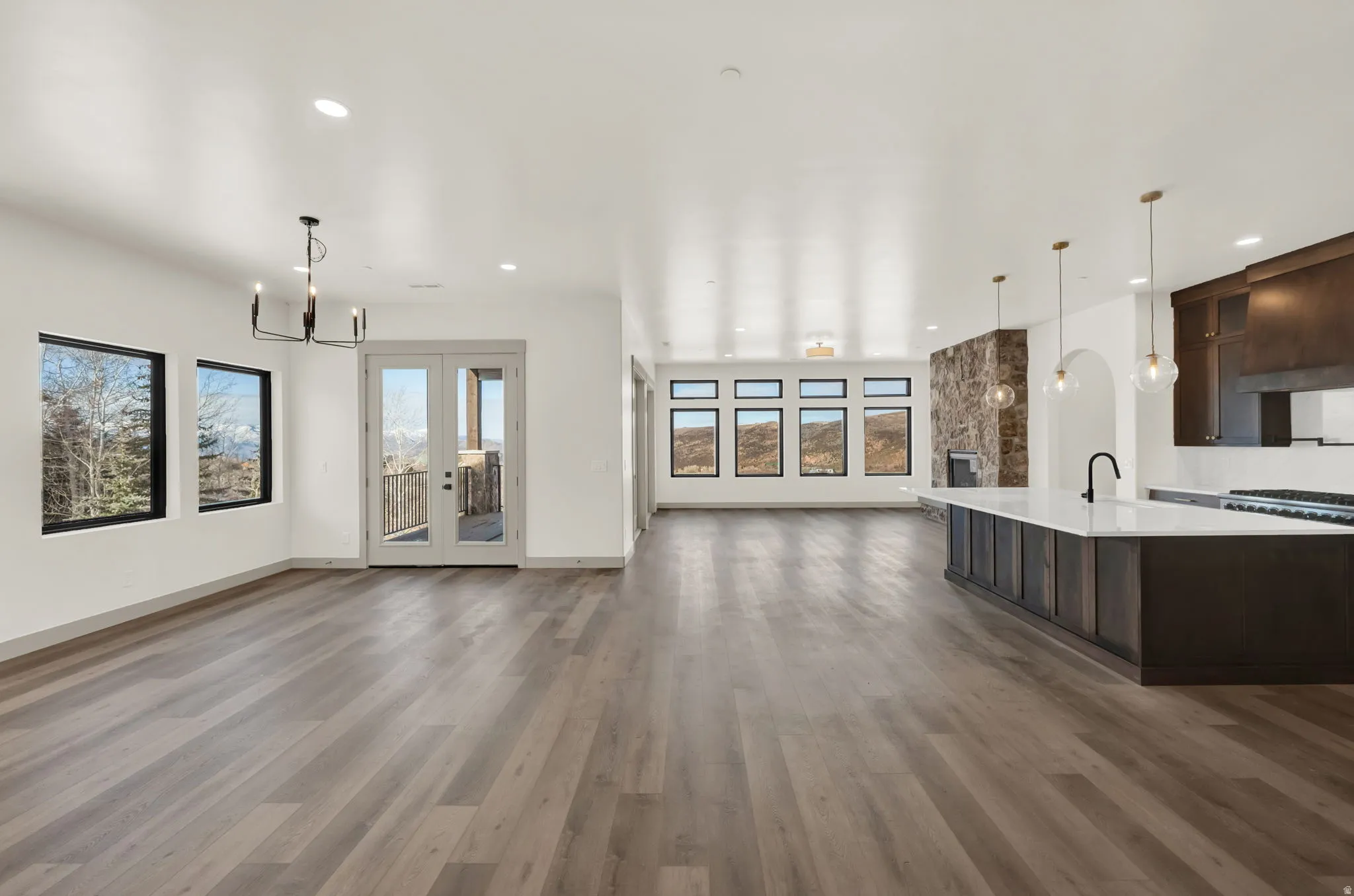Spacious great room with unobstructed views and French doors leading to covered deck.