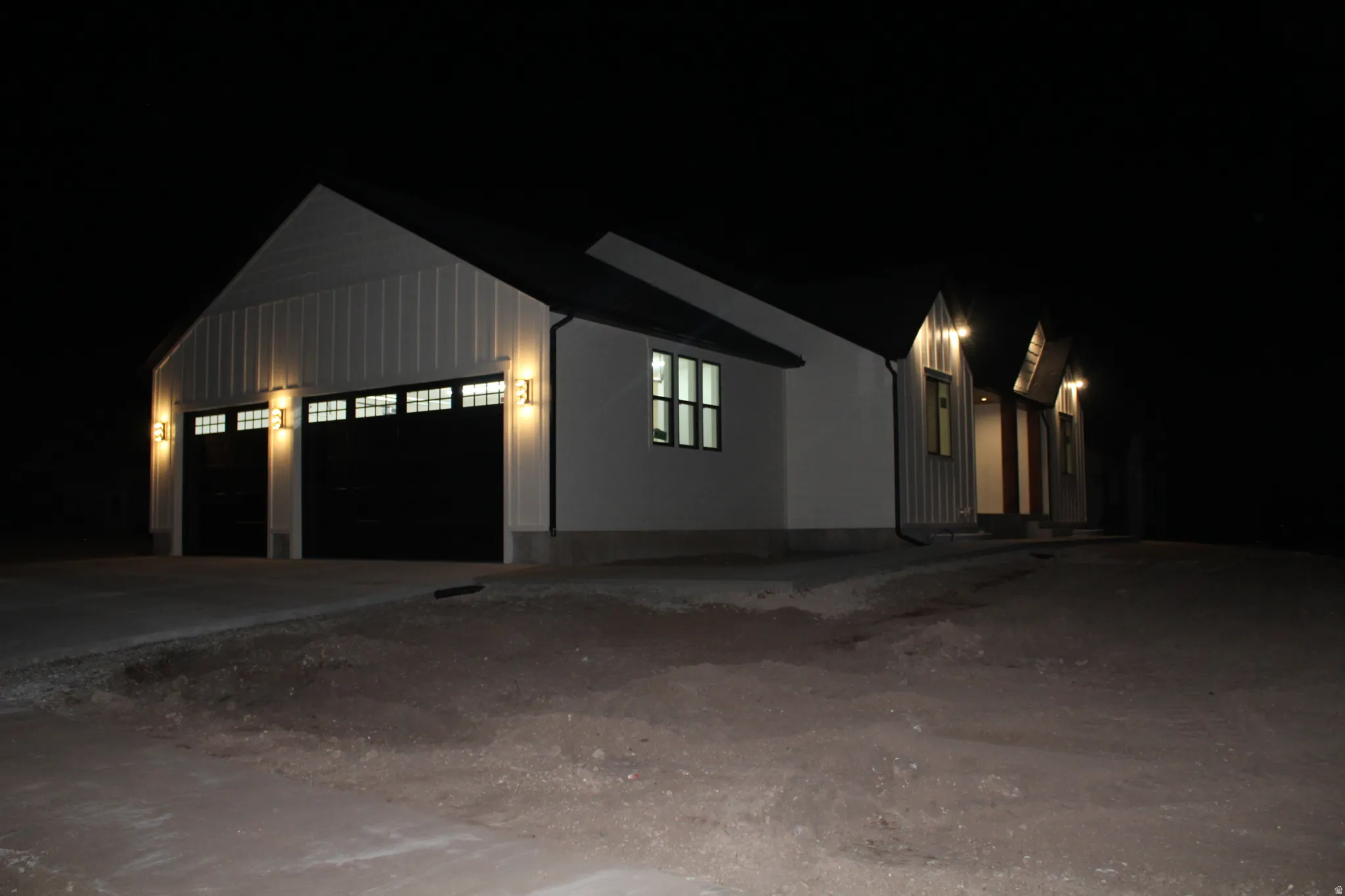 View of front of house featuring driveway, an attached garage, and board and batten siding