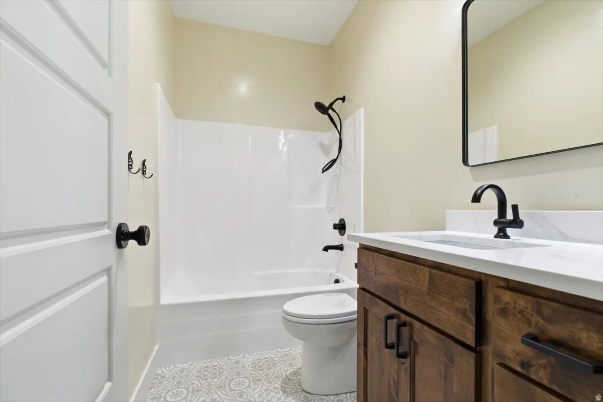 Bathroom featuring vanity and shower / tub combination