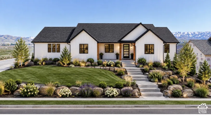 White board-and-batten siding with black trim windows, dark shingle roof, and wood-toned front entry column