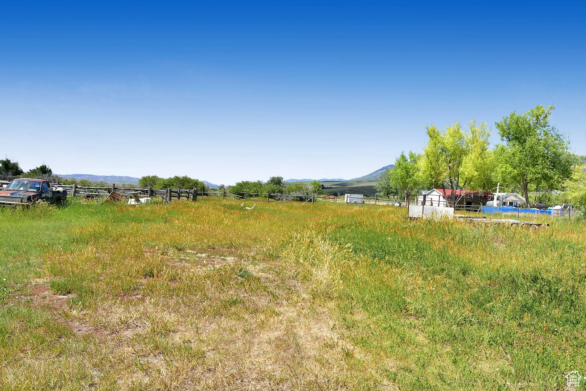 View of yard featuring a view of rural / pastoral area and a mountain view