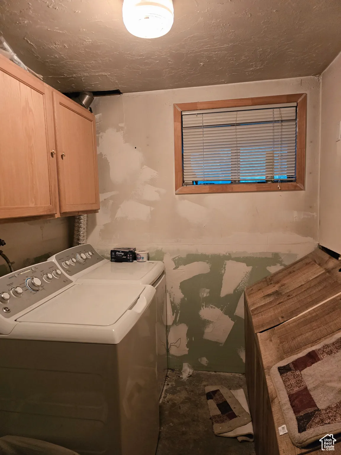 Laundry area featuring washing machine and dryer and cabinet space