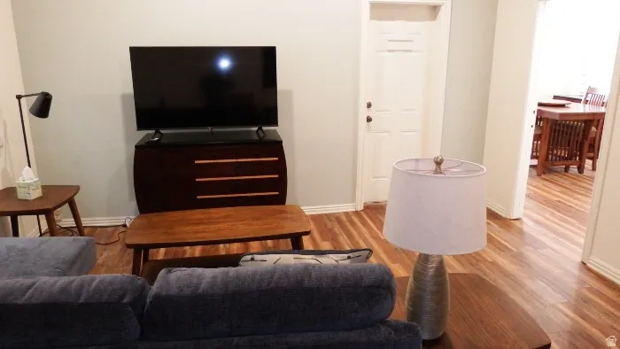 Living area featuring light wood-style flooring and baseboards