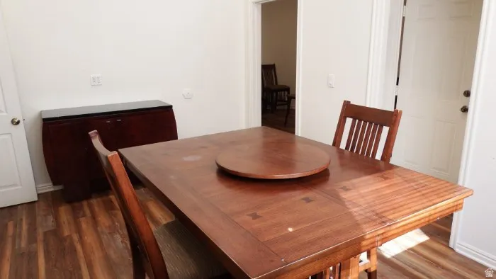 Dining room with dark wood finished floors and baseboards
