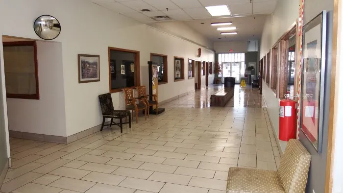Common area featuring a drop ceiling and a high ceiling