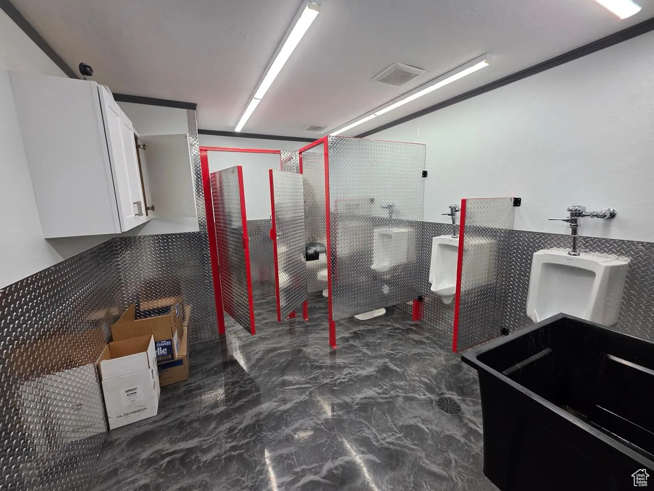 Below grade area featuring a wainscoted wall and tile walls